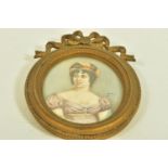 A LATE 19TH CENTURY MINIATURE PORTRAIT, depicting an elegant lady with head dress, mounted within an