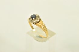 A SAPPHIRE AND DIAMOND CLUSTER RING, set with a principal circular shaped mixed cut sapphire, claw