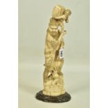 A LATE 19TH CENTURY CARVED IVORY FIGURE ATOP WOODEN STAND, depicting an oriental man with two