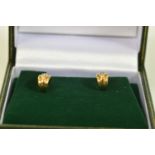 A PAIR OF YELLOW METAL DIAMOND EARRINGS, each designed as a brilliant cut diamond line scroll,