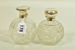 TWO GLASS SILVER TOPPED PRESSED BOTTLES, each designed as a rounded glass bottle with silver tops