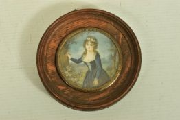 A WOODEN PORTRAIT MINIATURE, depicting a Georgian lady within a garden painting onto a tree, with