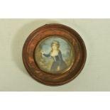 A WOODEN PORTRAIT MINIATURE, depicting a Georgian lady within a garden painting onto a tree, with