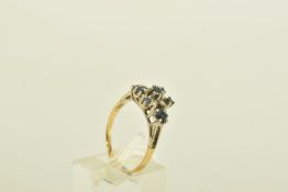A YELLOW AND WHITE METAL SAPPHIRE AND DIAMOND CLUSTER RING, the vari shape sapphires with six
