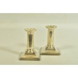 A PAIR OF SILVER DWARF CANDLE STICK HOLDERS BY HORACE WOODWARD & CO LTD, each designed as plain