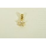 A YELLOW METAL DIAMOND FLORAL PENDANT, designed as a single cut diamond flower, suspended from an