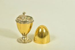 A SILVER EGG ORNAMENT, designed as a gold plated textured egg, opening to reveal a pond scene with