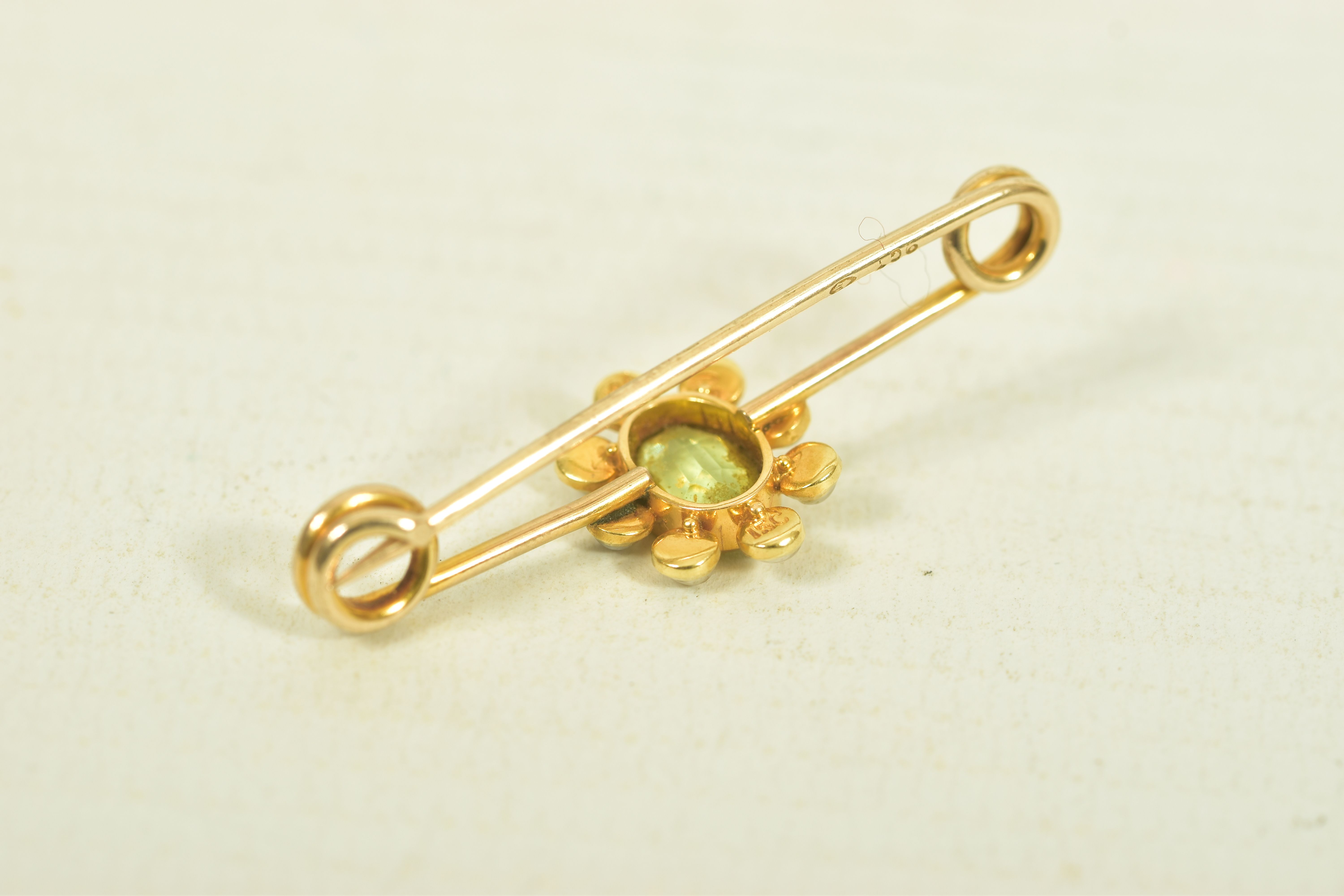 A YELLOW METAL PERIDOT AND SPLIT PEARL BAR BROOCH, the oval collet set peridot, within a split pearl - Image 3 of 3