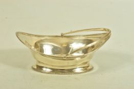 A GEORGIAN SILVER BASKET, of oval outline with plain polished beaded border and grooved handle,