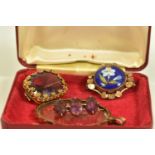 A SELECTION OF JEWELLERY, to include a gold plated enamel flower brooch, an oval shape amethyst