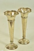 A PAIR OF EARLY 20TH CENTURY SILVER POSE VASES BY WALKER AND HALL, with tapering stem and undulating