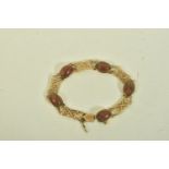 A 9CT GOLD MOSS AGATE BRACELET, comprising five oval moss agate cabochons each collet set,