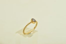 A 9CT GOLD TANZANITE SINGLE STONE RING, the oval shape tanzanite, to the bead detail band,