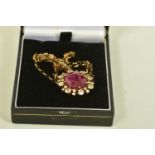 A MODERN GLASS FILLED RUBY AND ZIRCON PENDANT WITH CHAIN, the oval shape glass filled ruby,