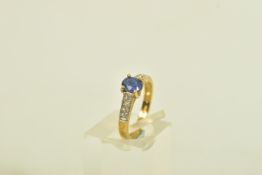 A 9CT GOLD SYNTHETIC SAPPHIRE AND COLOURLESS GEM RING, the oval synthetic sapphire, to the