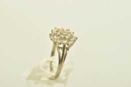 A 9CT WHITE GOLD BRILLIANT-CUT DIAMOND CLUSTER RING, with nineteen graduated diamonds to the