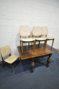 AN EARLY 20TH CENTURY OAK DRAW LEAF DINING TABLE, on turned legs united by a cross stretcher, open