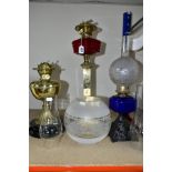 THREE OIL LAMPS, two with glass reservoirs, the tallest measuring approximately 54cm having a square