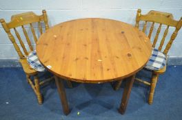 A PINE CIRCULAR KITCHEN TABLE, diameter 102cm x height 74cm, along with two chairs (general wear) (