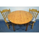 A PINE CIRCULAR KITCHEN TABLE, diameter 102cm x height 74cm, along with two chairs (general wear) (