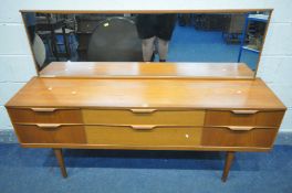 A MID CENTURY AUSTINSUITE TEAK DRESSING TABLE DRESSING TABLE, with a rectangular mirror, and six