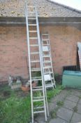 A SET OF 3.4M ALUMINIUM DOUBLE EXTENSION LADDERS (one rung bent) together with another set of 2.4M