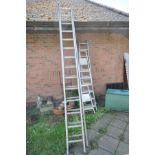 A SET OF 3.4M ALUMINIUM DOUBLE EXTENSION LADDERS (one rung bent) together with another set of 2.4M