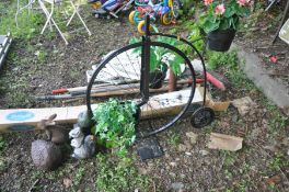 A BLACK PAINTED METAL FRAMED PLANT POT HOLDER in the shape of a penny farthing together with a small