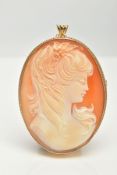 A 9CT GOLD CAMEO BROOCH, oval carved shell depicting a lady in profile, bezel setting with a fine