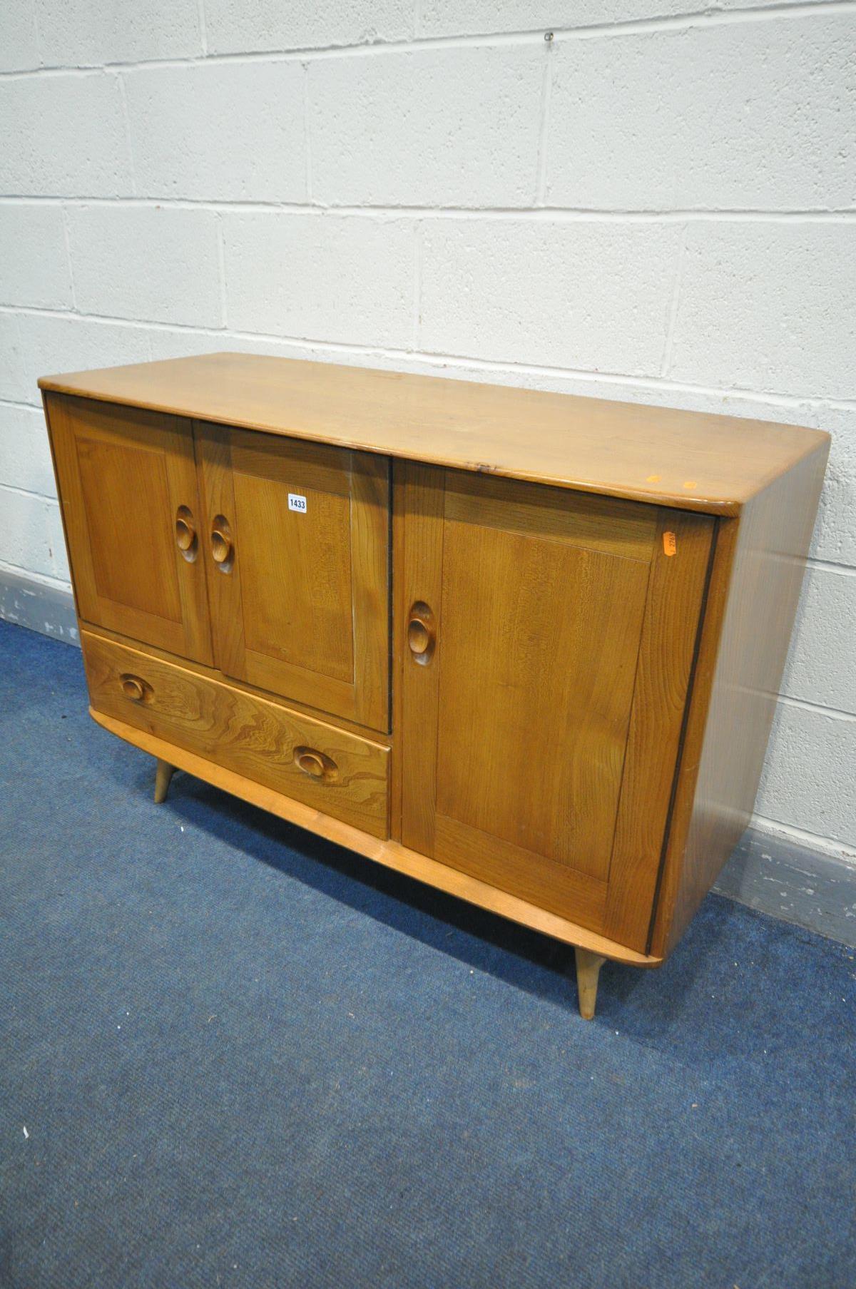 AN ERCOL MODEL 467 ELM AND BEECH SIDEBOARD, with double cupboard door above a single drawer, besides - Image 4 of 6