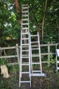 A SET OF DOUBLE EXTENSION LADDERS, with wheels, length 3.5M together with a platform ladder with 2 x