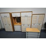 A TEAK AND WHITE FINISH BEDROOM FITMENT, comprising three wardrobes, dressing section and a chest of