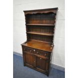 A SLIM REPRODUCTION OAK DRESSER, with two drawers, width 92cm x depth 40cm x height 175cm x height