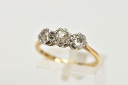 A THREE STONE DIAMOND RING, three old cut diamonds set in a white metal illusion setting,