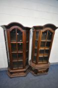 TWO SIMILAR OAK GLAZED SINGLE DOOR DISPLAY CABINETS, with dome top, canted corners and a single