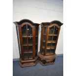 TWO SIMILAR OAK GLAZED SINGLE DOOR DISPLAY CABINETS, with dome top, canted corners and a single