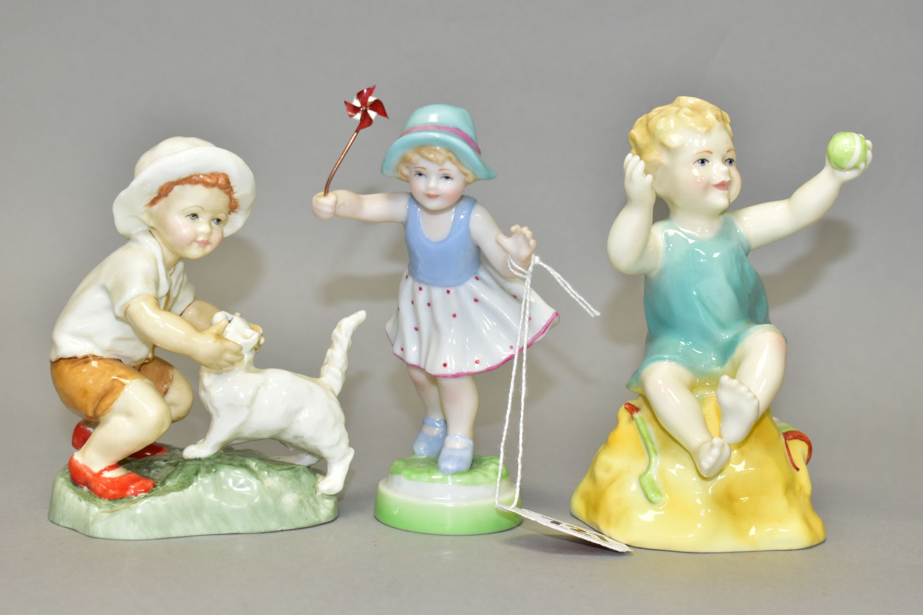 THRE ROYAL WORCESTER FIGURES, comprising 'Snowy' 3457, a small boy with a white cat, modelled by
