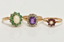THREE 9CT GOLD CLUSTER RINGS, the first an oval opal set with ten circular cut emeralds, set in