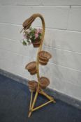 A MID CENTURY BAMBOO SNAKE PLANTER, complete with five bamboo baskets, height 124cm