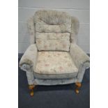 A FLORAL UPHOLSTERED WING BACK ARMCHAIR