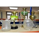 THREE OIL LAMPS, two with painted opaque glass reservoirs, the tallest measuring approximately