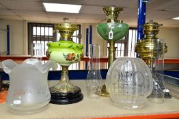 THREE OIL LAMPS, two with painted opaque glass reservoirs, the tallest measuring approximately