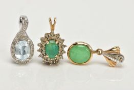 TWO YELLOW METAL PENDANTS AND A WHITE METAL PENDANT, the first an oval cut emerald set with a