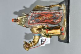 A COLD PAINTED SPELTER TABLE LIGHTER IN THE FORM OF TWO FIGURES WITH A CAMEL, in the style of