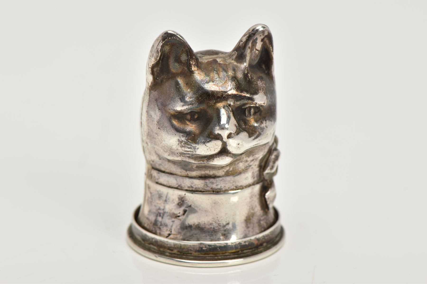 A SILVER CAT VESTA CASE, designed as a cat head with a ribbon round its neck, opens to the base with