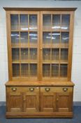 A 19TH CENTURY PITCH PINE FARMHOUSE BOOKCASE, the upper section with double astragal glazed doors,