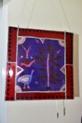 A CONTEMPORARY STAINED GLASS PANEL OF BIRDS AND TREES, leaded red glass border, fitted with