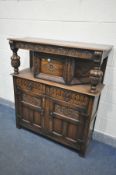 A REPRODUCTION CARVED OAK COURT CUPBOARD, the top with a single cupboard door, over two drawers