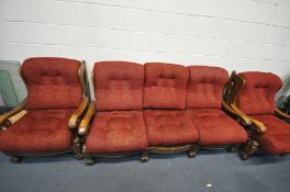 AN OAK FRAMED THREE PIECE SUITE, comprising a three seater sofa and a pair of armchairs, with red