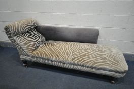 AN EDWARDIAN ZEBRA PRINT UPHOLSTERED CHAISE LONGUE, length 175cm (condition:-stains to upholstery)